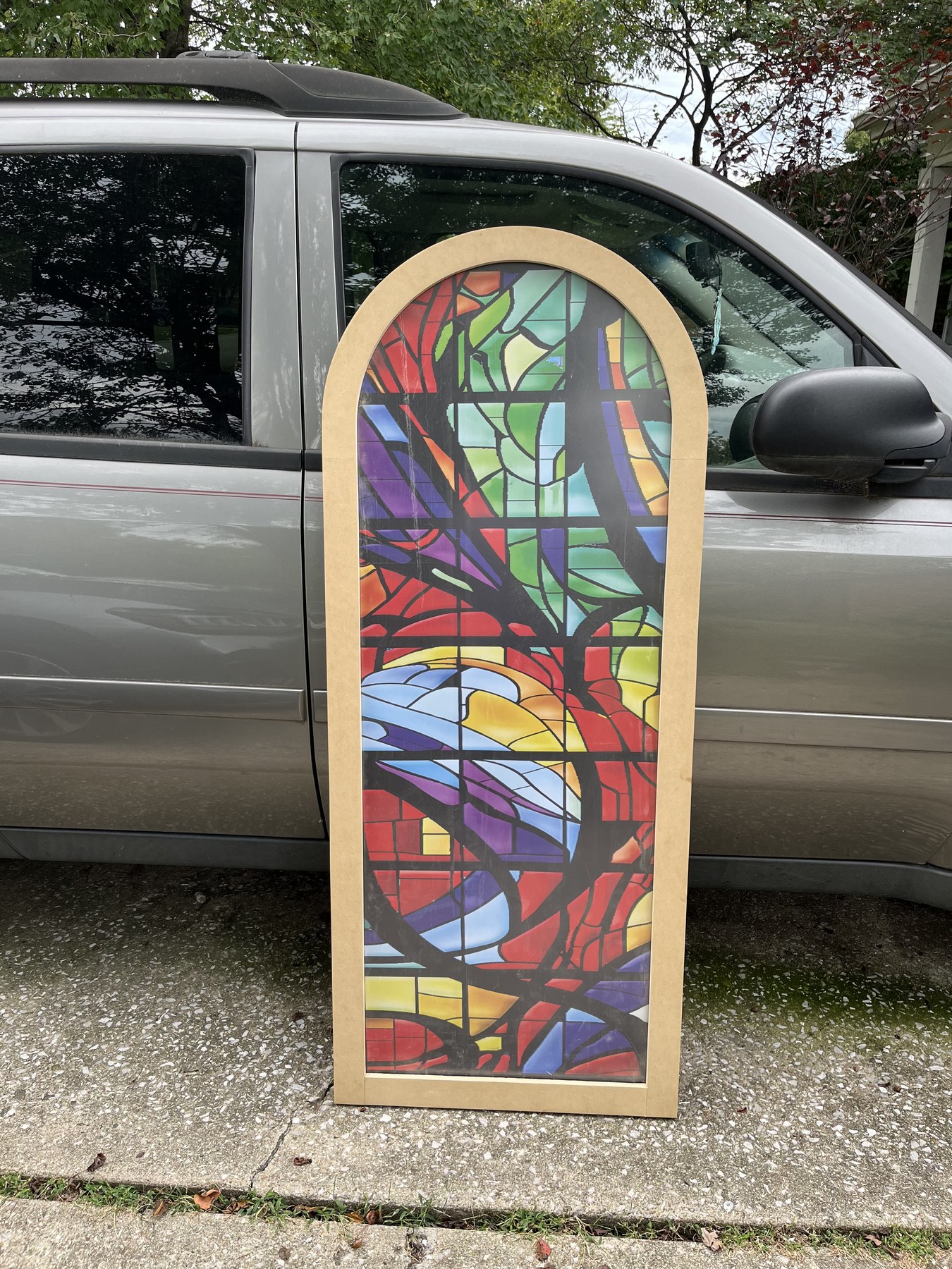 Arched Stained Glass Frame Clamped on Workshop Table During Glue-up